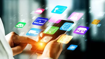 Person using smartphone with colorful app icons floating around.