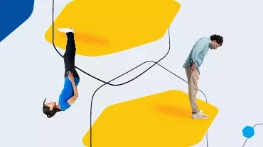 Two people standing on yellow shapes, one upside down and one leaning forward.