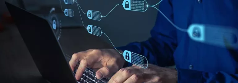 Person typing on a laptop with blockchain technology visuals overlayed.