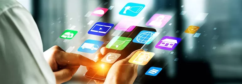 Person using smartphone with colorful app icons floating around.