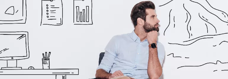 Man sitting and thinking in front of wall with drawings of graphs and landscapes.