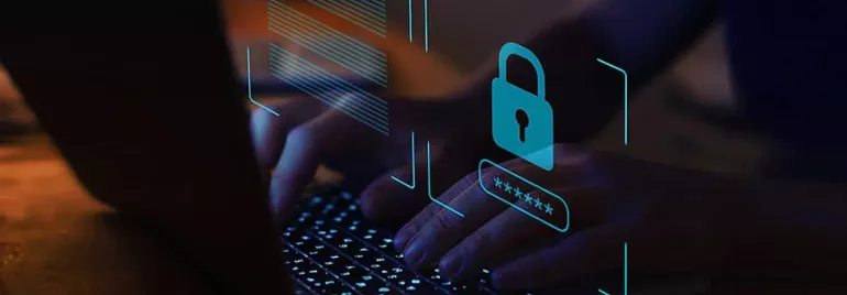 Person typing on a laptop with a digital lock icon overlay, symbolizing cybersecurity.