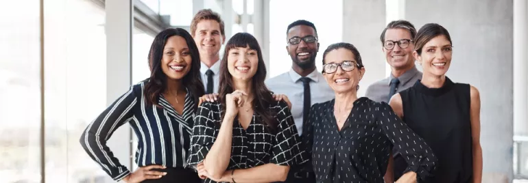 Group of professionals smiling in an office.