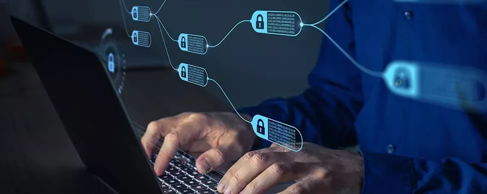 Person typing on a laptop with blockchain technology visuals overlayed.