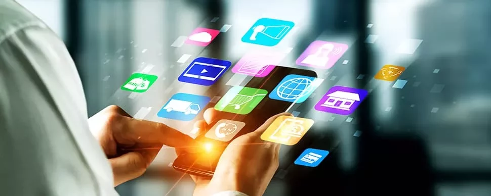 Person using smartphone with colorful app icons floating around.