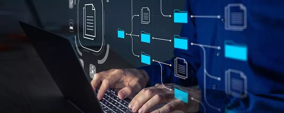 Person typing on laptop with digital file and folder icons overlayed.