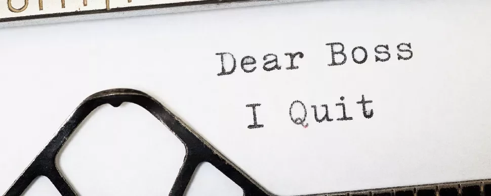 Typewriter with a typed note saying 'Dear Boss, I Quit.'