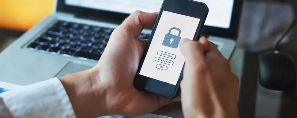 Person holding smartphone with a lock screen, displaying a security login.
