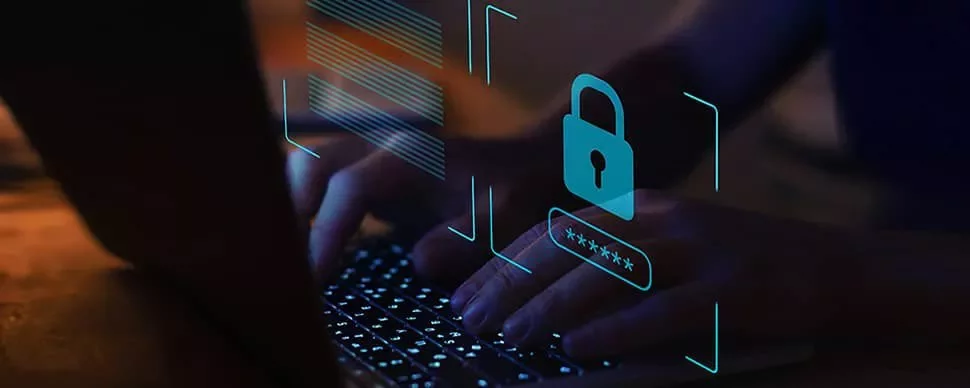 Person typing on a laptop with a digital lock icon overlay, symbolizing cybersecurity.