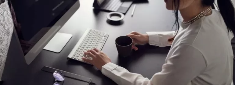 A professional preparing to write a farewell email to her colleagues before her departure.
